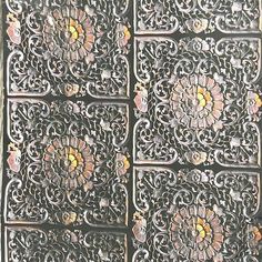 an intricately designed metal door with flowers on it