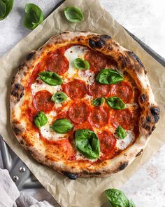 a pizza sitting on top of a piece of wax paper