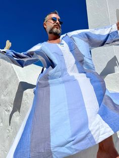 Hand made Mens caftan  cotton fabric comfortable CAFTAN for men  greek style kaftan  Handmade Handmade from start to finish Blue and white stripe caftan Best for yachtwear,  poolside  party or surf robe Front pocket kaftan Plus size caftan Small/ medium / large / xlarge / xxlarge / 3XL / 4XL  / 5XL / 6XL size options - for other sizes you can ask  Feel free to ask for custom made  Worldwide fast shipping for more caftans please visit my shop: www.etsy.com/shop/mnouss/ And my new shop link: www.etsy.com/shop/maisonmnouss/ And my new shop link- caftan and more-  www.etsy.com/shop/maisonmnouss/ To follow us on instagram: https://www.instagram.com/mnoussofficial/ Bohemian Striped Long Sleeve Kaftan, Striped Long Sleeve Bohemian Kaftan, Striped Long Sleeve Kaftan For Vacation, Striped Long Sleeve Kaftan For Summer, Striped Long Sleeve Summer Kaftan, Blue Long Sleeve Summer Thobe, Mens Caftan, Caftan For Men, Plus Size Caftan