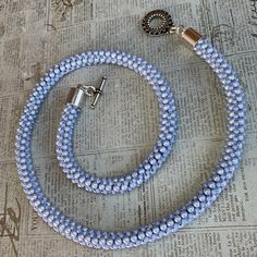 This gorgeous iridescent dreamy blue Swarovski pearl and cornflower blue beaded necklace is a stunner!    It is 20  1/4   inches long from end to end.  The light blue beads are 3mm Swarovski iridescent dreamy blue, glass pearls and the other blue ones are a cornflower blue, size 11/0 seed beads.  The bead weaving technique used to create this necklace is called cubic right angle weave.  The ends of the necklace are finished with silver toned 8mm barrel end caps which are attached to two silver colored twisted jump rings.  The two jump rings connect the silver plated pewter toggle clasp. Cubic Right Angle Weave, Light Blue Necklace, Blue Cornflower, Woven Necklace, Right Angle Weave, Blue Beaded Necklace, Necklace Beaded, Right Angle, Blue Pearl