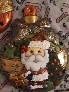 a christmas ornament with a santa clause on it's face and decorations