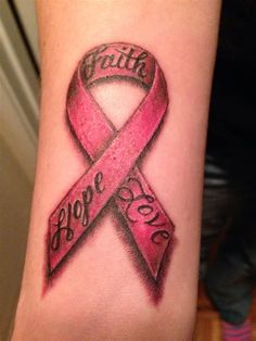 a woman's arm with a pink ribbon on it that says faith hope love