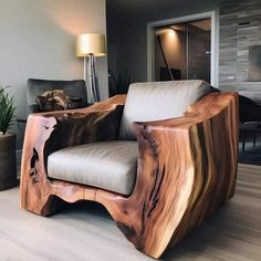 a wooden chair sitting on top of a hard wood floor next to a potted plant