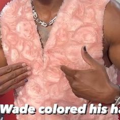 a man in a pink dress with his hands out and the words wade colored his hair