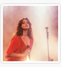 a woman in a red dress holding a microphone