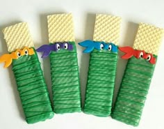 four decorated cookies in the shape of toothbrushes