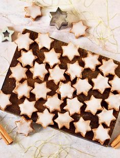 star shaped cookies on a cutting board with cinnamon sticks