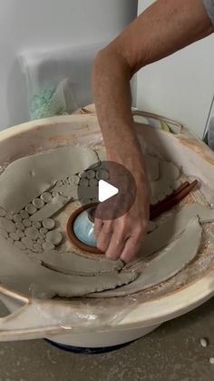 a man is making a bowl out of clay