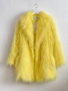 "Yellow, Oversize Fur Coat. Luxury, fluffy fabric, very soft. 100% polyester. Handmade made in London, UK.  Oversize style. Big collar. Long sleeves. Metal snap buttons (invisible) Two side pockets. Lenght 82cm - 1cm) Handmade in UK.  Model wears size S.  HOW TO CHOOSE A SIZE ?   Using a measuring tape, measure your bust, waist and hips (widest part) and compere with size chart.  SIZE CHART: (CM) B: Bust  H: Hips  XS - B: 83-88 cm  H: 90-95 cm  S - B: 88-93 cm H: 95-100 cm  M - B: 93-98 cm H: 100-105 L - B: 103-108 cm  H: 105-110 cm XL - B: 108-113 cm H: 110-115 cm CARE INSTRUCTIONS: Dry clean only, do not wash, do not iron, do not bleach.  Please message me before purchasing so I can check availability. If you wish this fur in any other colour, shorter or longer \"send message to seller\" Yellow Faux Fur Coat, Yellow Fur Coat, Fur Coat Outfits, Oversized Fur Coat, Oversize Coat, Fluffy Fabric, Oversize Style, Fuzzy Coat, Fluffy Jacket