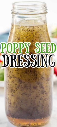 a jar filled with poppy seed dressing on top of a table