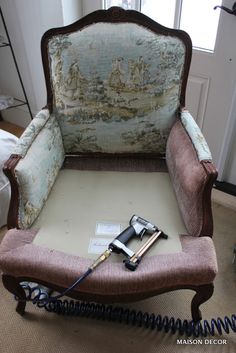 an old chair with hair dryers on top of it