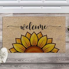 a welcome mat with a sunflower on it