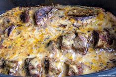 a casserole dish with meat and cheese on it in a crock pot