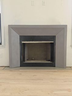 an empty room with a fire place in it