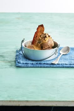 a bowl filled with ice cream sitting on top of a blue cloth covered place mat