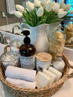 a basket filled with lots of different types of soaps and lotions next to a sink