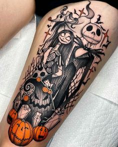 a person with a tattoo on their leg that has a skeleton and pumpkins in it