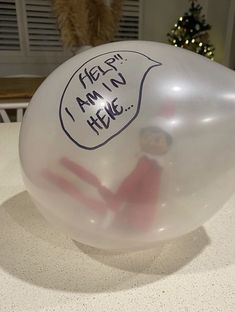 an inflatable balloon with the message help i am not here written on it