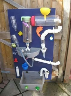 a water dispenser with several different types of bottles attached to the wall