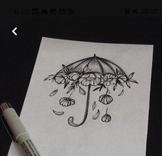 a drawing of an umbrella with flowers and raindrops on it, next to a marker