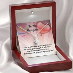 14k White Gold Over Stainless Steel 7mm round cut Cubic Zirconia ﻿Stylish gift box and message card Show your daughter how much you love her with this beautiful Alluring ribbon pendant necklace. This beautiful pendant is truly a one-of-a-kind gift for any daughter. The ribbon design is embellished with dainty cubic zirconia, which is followed by a beautiful 7mm round cut Cubic Zirconia. Crafted with 14k White Gold over Stainless Steel, this necklace dresses up any occasion. The adjustable oblate Elegant Birthday Gift Jewelry, Gift Ready, Elegant Jewelry Gift Ready For Birthday, Elegant Birthday Gift-ready Jewelry, Elegant Jewelry For Birthday Gift, Heart Pendant Jewelry With Gift Box, Heart Pendant Jewelry Gift With Box, Valentine's Day Birthday Gift Wrapped Jewelry, Elegant Birthday Gift Necklace, Gift Wrapped, Meaningful Round Pendant Jewelry As Gift