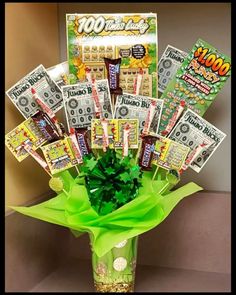 a vase filled with lots of money sitting on top of a counter next to a wall