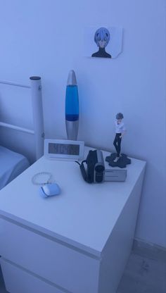 a bedroom with a bed, desk and toy figurine on top of it