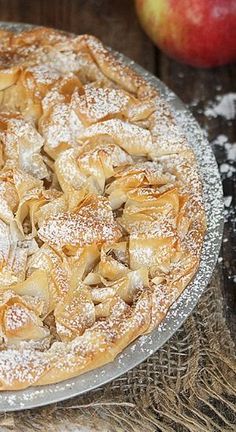 an apple pie with powdered sugar on top