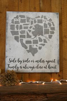 a wooden sign that says side by side on miles apart family is always close at heart