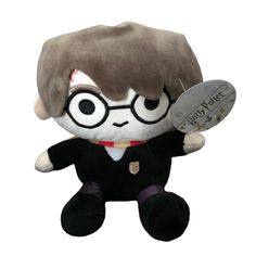 a harry potter stuffed animal with glasses and a tag on it's chest,