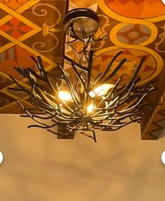 a chandelier hanging from the ceiling in a room with an artistic design on it