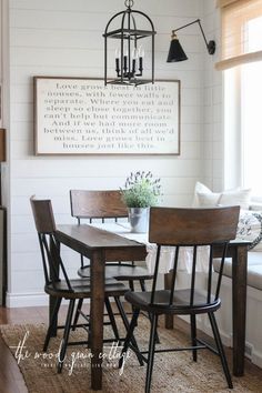 a dining room table with chairs and a chandelier hanging from it's ceiling