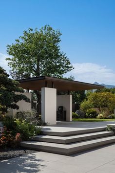 an outdoor pavilion with steps leading up to it and trees in the backgroud