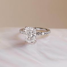 an engagement ring with a cushion cut diamond