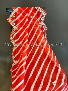 Red Organza Dupatta features a lehariya design with elegant embroidery and scalloped borders. Made from high-quality organza fabric, this dupatta is lightweight and comfortable to wear. Perfect for adding a touch of elegance to any outfit, it's a must-have for any fashionista. Lehariya Dupatta, Elegant Embroidery, Organza Dupatta, Organza Fabric, Borders, Red And White, Red, Fabric, How To Wear