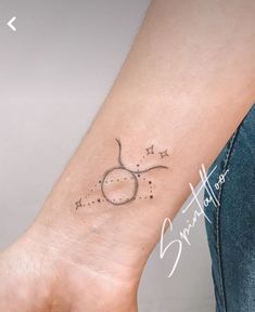 a woman's arm with a small star tattoo on it