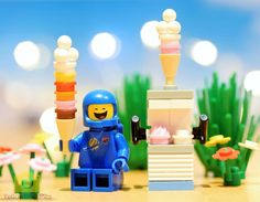 there is a lego man standing in front of some ice cream cones and building blocks