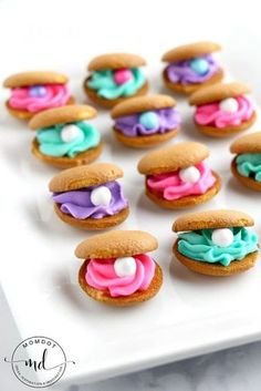 there are many cookies that have frosting on them and sprinkles in the shape of sandwiches