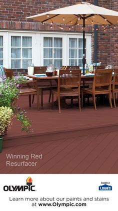 an outdoor dining table with chairs and umbrella