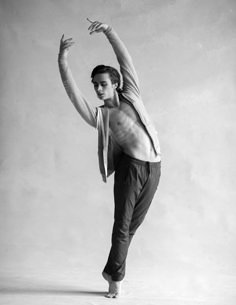 a shirtless man is posing for the camera with his arms in the air and one hand up