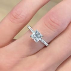 a woman's hand with a diamond ring on it