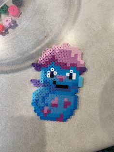 a piece of perler bead art that looks like the smurfs character