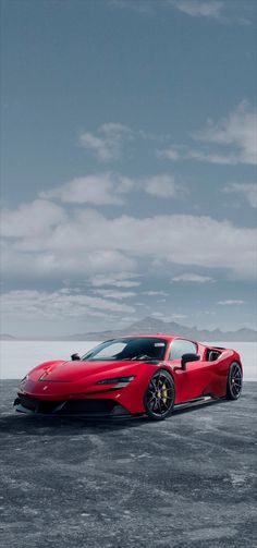 the red sports car is parked in an empty lot