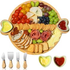 a wooden platter filled with cheese, crackers, fruit and vegetables next to utensils