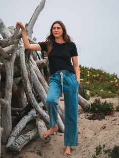 Inspired by vintage utility workwear, the Easy pant has an elastic waist with drawcord and is made of cotton and hemp making them strong, breathable and with anti-microbial properties. Easy to wear and easy on the planet. Sizing: XS: 24-25, S: 26-27, M: 28-29, L: 30-31, XL: 32-33 (if you are in between sizes, size up) Fabric: 80% Cotton, 20% Hemp. Color-way: Medium Denim Blue. Models are 5'9" and both wearing size small with a 28" inseam. Machine wash cold. Tumble dry on low. Sweat Sets, 90s Tees, Simple Tees, Elastic Waist Pants, Sweaters And Leggings, Lifestyle Shop, Denim Pant, Waist Pants, New Set