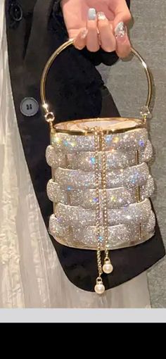 This stunning Crystal Bucket bag has now dropped! This bag would look perfect with any occasion, especially a bridesmaid outfit!  Order will take between 3-5 weeks this is dependent on demand and manufacturing the bag. However, due to off season it has been taking less than 2 weeks for customers to receive their orders. Gold Bucket Shoulder Bag For Formal Occasions, Luxury Rectangular Bucket Bag For Party, Elegant Silver Bucket Bag For Evening, Glamorous Evening Bucket Bag, Party Evening Bag With Detachable Handle, Bucket Shape, Party Bucket Evening Bag With Detachable Handle, Gold Bucket Bag For Evening, Gold Handheld Bucket Bag For Evening, Gold Pouch-shaped Bucket Bag For Evening