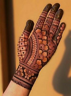 a woman's hand with henna on it