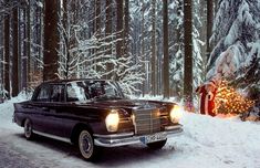 an old car is parked in the snow