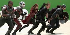 the avengers movie is being filmed in front of a green screen with people dressed as superheros