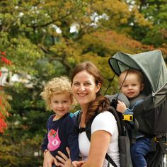 a woman and two children are smiling for the camera